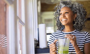 Smiling women drinking a smoothie